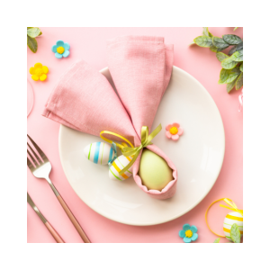 a white plate decorated with pink cloth and different colored items with a spoon and fork placed on a side